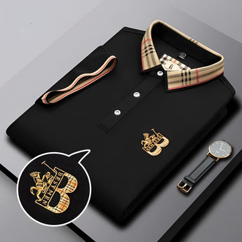 Black designer polo shirt with plaid collar and gold crest logo on chest.