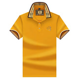 Black designer polo shirt with plaid collar, gold crest, yellow color, 3XL size.