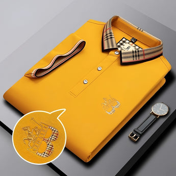 A black designer polo shirt featuring a plaid collar and gold crest.