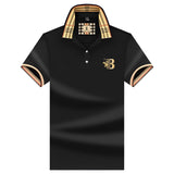 Black designer polo shirt with plaid collar and gold crest, size 3XL.