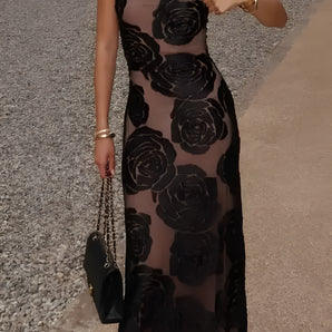 Black floral sheer one-shoulder evening dress with a fitted waist and flowing gown design.