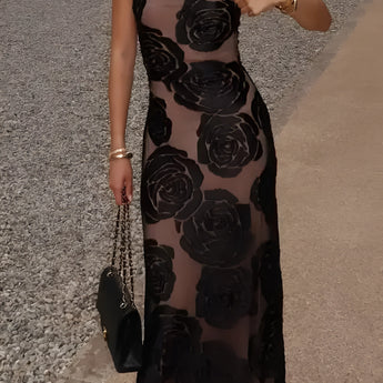 Black floral sheer one-shoulder evening dress with a fitted waist and flowing gown design.