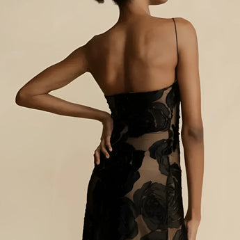 Black floral sheer one-shoulder evening dress showcasing a sheath silhouette with a fitted waist, featuring a single sleeve and elegant design.