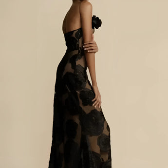 Black floral sheer one-shoulder evening dress showcasing an elegant design with sheer fabric, a fitted waist, and asymmetrical neckline, ideal for formal occasions.