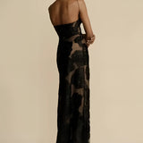 
A black floral sheer one-shoulder evening dress featuring elegant floral patterns, showcasing a fitted waist and a flowing gown design.