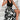 Elegant black floral sleeveless midi dress ideal for summer formal events, featuring a fitted waist and flowing skirt. Model wearing size XL(44).