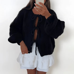 Black oversized fuzzy cardigan with a fluffy texture and toggle closure, featuring long sleeves and a cozy collar.