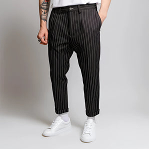 Men's black high-waist slim fit pinstripe dress pants, ankle-length, styled with a blazer.
