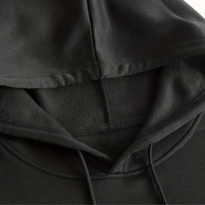 Black hoodie with soft texture and comfortable fit, featuring deep pockets and durable material.