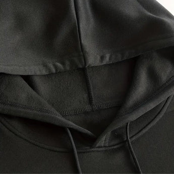 Black hoodie with soft texture and comfortable fit, featuring deep pockets and durable material.