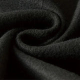 Black hoodie with a soft texture and comfortable fit, featuring durable material and deep pockets, displayed in a monochrome setting.