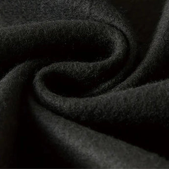 Black hoodie with a soft texture and comfortable fit, featuring durable material and deep pockets, displayed in a monochrome setting.