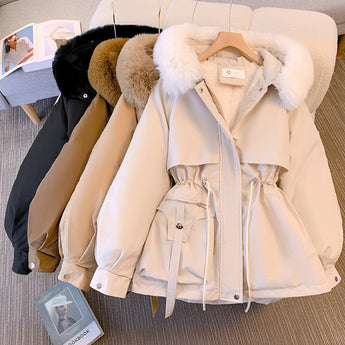 Black insulated parka with a luxury fur hood and adjustable waist, featuring a fashionable design with collar and sleeves. The parka showcases beige accents and natural materials, styled in a way that resembles a blazer or dress shirt pattern.