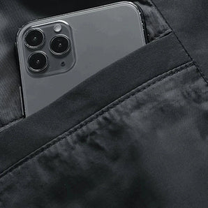Black iPhone with triple-camera setup featuring an anti-glare case, showcased in a sleek grey color.