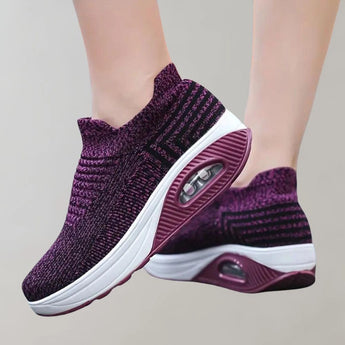 A pair of black knit slip-on sneakers designed for breathability and lightweight comfort, ideal for sports and walking activities.