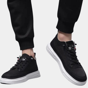 Black lace-up low-top sneakers for men with a sleek design, featuring white and grey accents, photographed on a clean background.