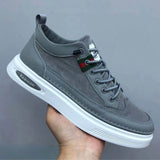 Gray low-top lace-up sneakers for men, designed for comfort and fashion, featuring a sporty and casual style suitable for walking and outdoor activities.