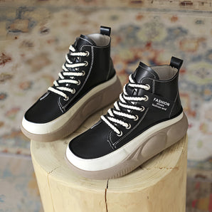 Black leather high-top sneakers with thick soles, designed for urban fashion.