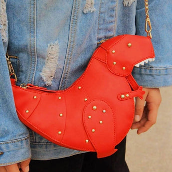 Black leather horse-shaped crossbody bag with gold chain strap, featuring a unique and artistic design.