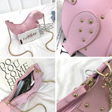 Black leather horse-shaped crossbody bag with a gold chain strap, displayed against a white background.