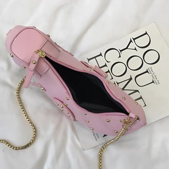 Black leather horse-shaped crossbody bag with a gold chain strap, designed as a shoulder bag.