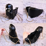 Black leather horse-shaped crossbody bag with a gold chain strap.