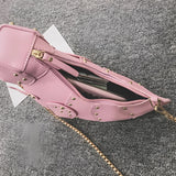 Black leather horse-shaped crossbody bag featuring a gold chain strap, designed as a stylish fashion accessory.