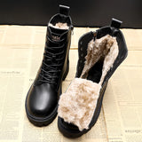 Black leather insulated combat boots with a fur lining, featuring a rugged sole design.