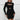 A woman wearing a black long sleeve cut-out bodycon mini dress, suitable for party wear, showcasing a form-fitting style with a sheath silhouette. She is smiling, with attention to the shoulder and neck area, emphasizing the elegant design of the garment. The dress is in size XL.