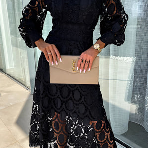 Elegant black long sleeve lace evening gown with intricate lace detailing on the sleeves and neckline, showcasing a sophisticated and stylish design. The gown is form-fitting at the waist, emphasizing a graceful silhouette suitable for formal occasions.