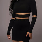 Black long sleeve midi cocktail dress with sheer mesh detail and curve-hugging fit.