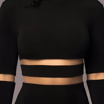 
A black long sleeve sheer mesh curve-hugging midi cocktail dress, featuring a fitted silhouette that accentuates the waist and thighs. The dress showcases the arms and shoulders through the sheer fabric, highlighting the delicate textile details.