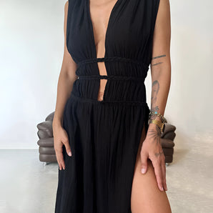 Black sleeveless maxi dress featuring a plunging neckline and a high slit, perfect for evening wear.