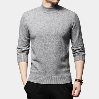 A man wearing a gray 4XL slim fit wool turtleneck sweater, showcasing the winter fashion style. The sweater features a snug fit around the neck and arms, highlighting a clean, sophisticated look. The background is neutral, focusing attention on the garment.
