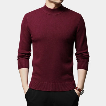 Men's slim fit wool turtleneck sweater in black, showcasing winter fashion. The image features a close-up of the sweater's neckline, sleeves, and waist, highlighting its sleek design with a model wearing a stylish watch. The sweater is complemented by a dress shirt collar peeking through.