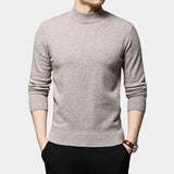 Black wool turtleneck sweater for men, slim fit, worn by a model with a khaki outfit, showcasing winter fashion style. Model's arm is visible with a watch, suggesting a polished look. Sweater is the centerpiece of the image.