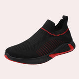 Men's black slip-on sneakers featuring a breathable mesh design, red accents, and a flexible sole, suitable for outdoor walking and athletic activities.