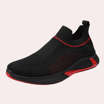 Men's black slip-on sneakers featuring a breathable mesh design, red accents, and a flexible sole, suitable for outdoor walking and athletic activities.
