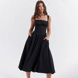 A black midi dress featuring spaghetti straps and an A-line silhouette, suitable for evening and cocktail events, displayed on a mannequin.
