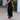 
A luxurious black off-shoulder evening gown featuring tiered fringe detailing, designed as a one-piece garment, tailored for an elegant fit in an XL size.