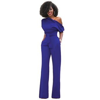 A model wearing a blue one-shoulder belted jumpsuit, designed as elegant formal evening wear, showcasing fashion design elements and a stylish waist belt.