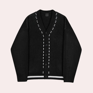 
A men's black oversized chunky knit V-neck cardigan displayed on a mannequin, highlighting its luxurious and fashionable design with a textured knit pattern, long sleeves, and an open front.