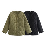 Women's black oversized quilted jacket with a lightweight design, featuring long sleeves and a stylish urban puffer pattern.
