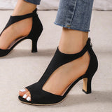 
A pair of black peep-toe heels with a comfortable low heel design, perfect for summer wear. The shoes are on a white background, showcasing their stylish and versatile appearance.