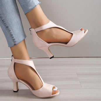 Black peep-toe heels with a low heel, showcasing the shoe's design on a model's foot, perfect for summer and suitable for both casual and bridal occasions.