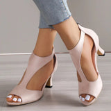 Beige peep-toe heels with a low heel, worn by a model, displaying the shoe's comfortable fit and summer style.