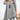Woman wearing black plaid hem dress with button detail in light gray, featuring long sleeves and a fall fashion style.