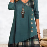 Woman wearing a black plaid hem dress with button detail, showcasing fall fashion; dress has a tartan pattern, long sleeves, and is paired with a green outerwear piece in size 3XL.