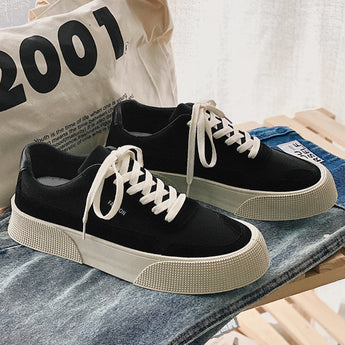 Black platform fashion sneakers with a textured sole, ankle-height design, and lace-up front, featuring a minimalist aesthetic suitable for walking and casual sportswear.