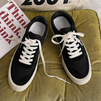 Black ankle-height platform fashion sneakers with a textured sole, designed for outdoor walking.